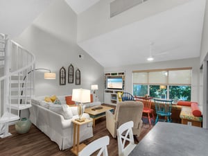 Relax in your bright, open living space with soaring ceilings, cozy seating, and colorful accents that create the perfect vacation retreat.