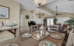 Your coastalthemed dining space flows beautifully into the living area, where warm beige tones and nautical touches create a relaxing atmosphere.