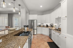The gourmet kitchen awaits with granite counters, stainless appliances, and pendant lighting creating the perfect space for culinary adventures.