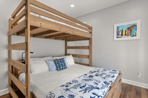 Sleep soundly in the cozy bunk bed with nauticalthemed linens and coastal artwork creating a charming retreat.