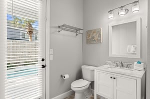 The pristine guest bathroom features marble countertops, modern fixtures, and plenty of natural light to refresh yourself during your stay.