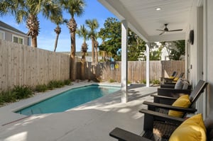 Your private pool oasis awaits under swaying palms, where comfortable seating and tropical shade create the perfect retreat.