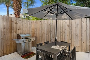 Relax under your private patio umbrella while savoring meals from your dedicated BBQ grill in this peaceful outdoor dining space.