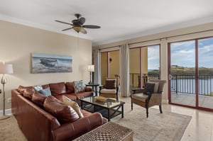 Unwind in your gulf and lakefront living room where rich leather furnishings and panoramic water views create the perfect backdrop for relaxation.