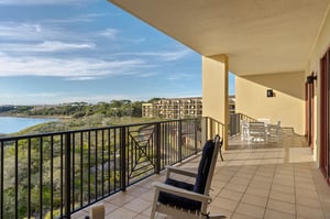 Unwind on your first floor private gulf and lakefront balcony with stunning water views and comfortable seating for peaceful morning coffee or evening relaxation.