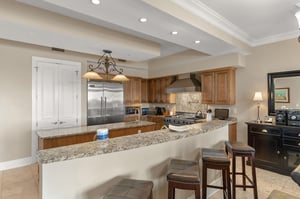 Your gourmet kitchen features granite countertops, stainless appliances, and a breakfast bar perfect for morning coffee or casual dining.