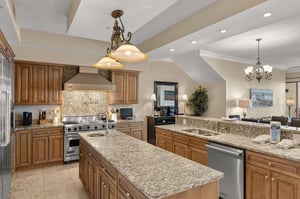 Your gourmet kitchen awaits with granite countertops, professional appliances, and elegant lighting perfect for creating memorable meals together.