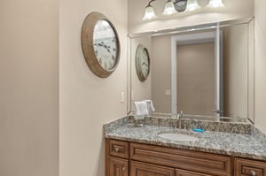 Freshen up at your elegant granite vanity with vintage charm and perfect lighting for your morning routine.