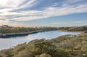 Scenic waterway winds through natural coastal landscape with charming vacation homes dotting the peaceful shoreline.