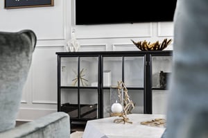 Relax in your elegant living space featuring a stylish glass cabinet and premium entertainment setup for cozy evenings.