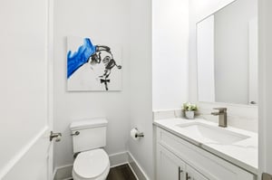 Fresh white powder room with modern vanity and artistic flair for your comfort.