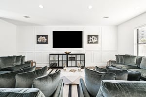 Sink into plush velvet seating while watching your favorite shows on the 100 inch TV in this elegant living space.