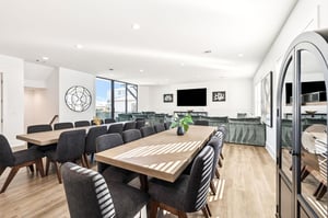The group dining space features elegant tables, modern seating, and natural light streaming through large windows for memorable meals together.