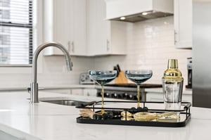 Mix cocktails in the sleek, modern kitchen complete with premium appliances and elegant bar accessories for entertaining.