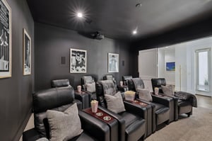 The private theater awaits with plush recliners and perfect lighting for movie nights with family and friends.