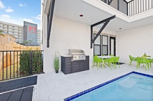 The private patio oasis features a sparkling pool and BBQ setup perfect for al fresco dining.