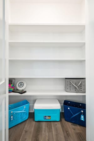 Your organized storage closet keeps beach gear and coolers perfectly arranged for spontaneous adventures.