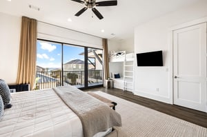 Unwind in your spacious bedroom featuring a comfy king bed, builtin bunk nook, and private balcony overlooking the neighborhood.