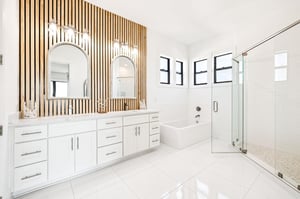 Indulge in your private spalike retreat with elegant wood slat accents, soaking tub, and spacious glass shower for ultimate relaxation.