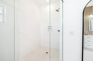 Step into your spalike shower with sleek glass doors and rainfall head for pure relaxation.