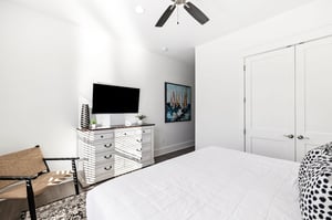 Your bright bedroom features a comfortable bed, flatscreen TV, and stylish furnishings for a restful stay.