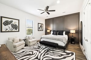 Unwind in your elegant bedroom featuring a cozy seating area and striking zebraprint rug that adds personality to your peaceful retreat.