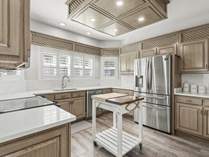 Your gourmet kitchen awaits with elegant cabinetry, modern appliances, and a charming moveable island perfect for culinary adventures.