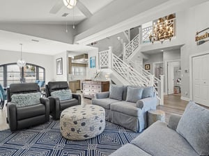 Relax in your openconcept living space featuring soaring ceilings, plush seating, and coastal charm that makes every moment feel like vacation.