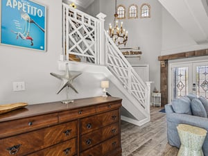 Relax in your charming coastal living space with elegant details and warm wood accents perfect for unwinding after beach days.