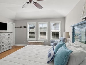 Drift off to coastal dreams in your serene bedroom, where soft blue linens and weathered nautical touches create perfect beachside tranquility.