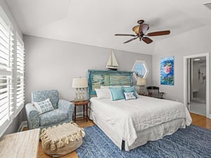 Drift off to sleep in this coastalinspired bedroom with ocean breezes from your ceiling fan and nautical touches throughout.