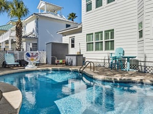 Your private pool awaits with crystalclear water and turquoise patio furniture for ultimate relaxation.