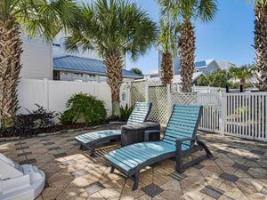 Relax on comfortable lounge chairs surrounded by swaying palms in your private tropical oasis with stylish patio furniture.