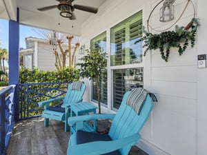 Unwind on your private covered porch with turquoise Adirondack chairs and soothing ceiling fan breeze.