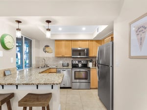 Your fully equipped kitchen invites culinary adventures with granite countertops, stainless steel appliances, and a cozy breakfast bar for morning coffee.