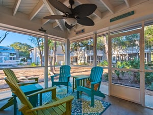 Relax in your screened porch with colorful Adirondack chairs and tropical garden views. The ceiling fan keeps you comfortable yearround.