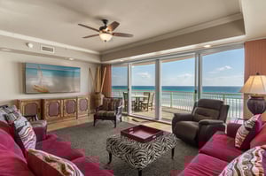 Sink into plush seating while ocean waves dance beyond your panoramic windows—your perfect beachfront retreat awaits.