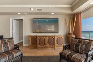 Relax in your spacious living room with stunning ocean views through floortoceiling windows and comfortable seating for the perfect beach getaway.