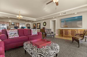 Unwind in your spacious living room where rich burgundy seating and coastal artwork create the perfect retreat after exploring.