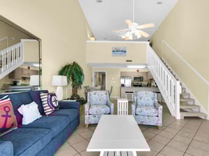 Step into your bright coastal retreat where nautical touches and vaulted ceilings create the perfect beachside atmosphere for relaxing.