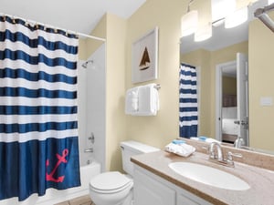 Your private bathroom features a relaxing tubshower combo with nautical charm, plus soft towels and coastal décor for your comfort.