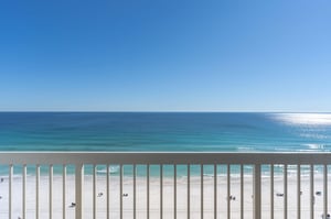 Pristine white sand beach and turquoise waters stretch endlessly from this oceanfront balcony, creating the perfect backdrop for relaxation.
