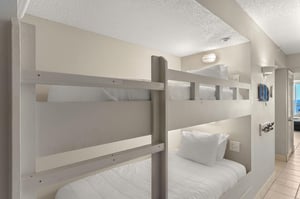 The bunk area features comfortable builtin beds with crisp linens and personal reading lights for a cozy nights sleep.