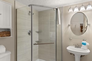 Freshen up in the elegant guest bathroom with a spacious glass shower