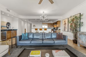 Sink into this stylish blue leather sofa and enjoy the openconcept living with modern kitchen, artistic touches, and warm wood accents throughout.