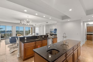 Your gourmet kitchen features granite countertops and premium appliances, with stunning views beckoning from the living area beyond.