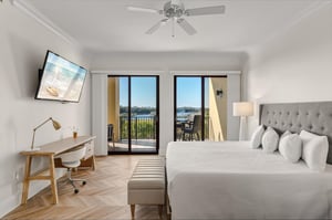 Wake up to stunning gulf and lake views from your bright, modern bedroom featuring crisp linens and a private balcony perfect for morning coffee.