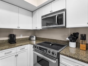 Your fully equipped kitchen awaits with granite countertops, stainless steel appliances, and everything needed to create delicious meals during your stay.