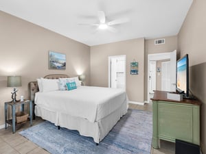 Drift off in your coastal retreat with crisp linens, oceanthemed touches, and modern comfort—complete with ceiling fan and flatscreen TV.