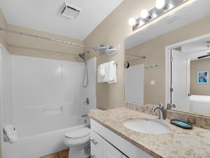 The bathroom features fresh towels, and a soothing tubshower combo for unwinding after your adventures.